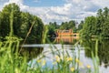 Scenic view from lakeside with meadow flowers on old Arch Bridge Royalty Free Stock Photo