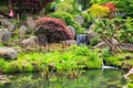 Scenic view of a landscaped rock garden with a flowing waterfall Royalty Free Stock Photo