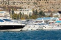 Scenic view of many luxury sailing fishing boat and charter rental speedboats moored at mountain harbor lake bay against Royalty Free Stock Photo