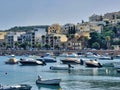 Scenic view of many luxury sailing fishing boat and charter rental speedboats moored at mountain harbor lake bay against mountain Royalty Free Stock Photo