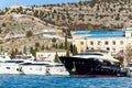 Scenic view of many luxury sailing fishing boat and charter rental speedboats moored at mountain harbor lake bay against Royalty Free Stock Photo