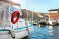 Scenic view of many sailing fishing boat and charter rental speedboats moored at mountain harbor lake bay against warm Royalty Free Stock Photo