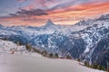 Scenic view of snowy mountain range against cloudy sky during sunset in alps Royalty Free Stock Photo