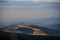 Scenic view of a mountain range on a sunny day, with white fluffy clouds Royalty Free Stock Photo