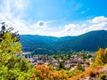 Scenic view of a mountain valley in autumn. Colourful countryside landscape with mountain forests and traditional houses. Balkan