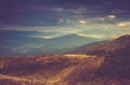 Scenic view of mountains, autumn landscape with colorful hills at sunset.