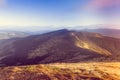 Scenic view of mountains with colorful hills at sunset. Royalty Free Stock Photo