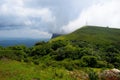 Scenic view of the Mullayanagiri Peak touching the clouds on a sunny day in Karnataka, India