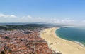 Scenic view of Nazare beach. Coastline of Atlantic ocean. Portuguese seaside town on Silver coast. White houses with red tiled Royalty Free Stock Photo
