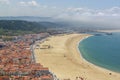 Scenic view of Nazare beach. Coastline of Atlantic ocean. Portuguese seaside town on Silver coast. White houses with red tiled Royalty Free Stock Photo