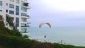 Scenic view of a no engine paraglider flying a very low altitude in Barranco district of Lima