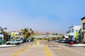 Scenic view of Ocean avenue in downtown Cayucos.Cars parked along the street. Dense morning fog covers hills - Cayucos, California