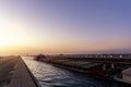 Scenic view od big cargo freight tugboat barge boat ship sailing by german inland canal Magdeburg bridge against warm