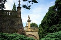 Scenic view of an old castle bridge surrounded by lush nature on blue sky background Royalty Free Stock Photo