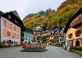 Scenic view of the old town square of Hallstatt, with a statue in the center, traditional colorful houses Royalty Free Stock Photo