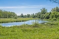 Scenic view of the park in the center of the big city in the summer. With a lagoon in the middle and green trees. Royalty Free Stock Photo