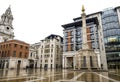 A scenic view of Paternoster Square with a tall column in the centre and St Paul`s Cathedral on the background, London, England Royalty Free Stock Photo