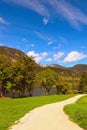 Scenic view of pathway for hiking around picturesque Bohinj Lake in sunny autumn day. Beautiful nature landscape Royalty Free Stock Photo
