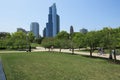 Scenic view of people riding bicycles in a green park against modern skyscrapers in Chicago Royalty Free Stock Photo