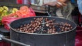 Scenic view of a person roasting chestnuts in the stall