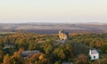 Scenic view on Pidkamin inselberg on adjacent hill and nearby village in Brody region of Galychyna, Ukraine