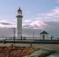 Scenic view of a pier with a lighthouse and an array of colorful flowers