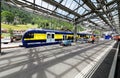 Scenic view of a platform in Lauterbrunnen Station with a train parking on the track & beautiful sunlight shining