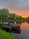 Scenic view of pond with moored boat at sunset Royalty Free Stock Photo