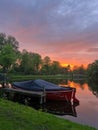 Scenic view of pond with moored boat at sunset Royalty Free Stock Photo
