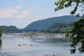 Scenic view of the Potomac River, with people lounging on lazy river tubing floats in the water on a hot summer day Royalty Free Stock Photo