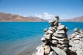 Scenic view of prayer rocks stacked atop one another, overlooking a tranquil lake