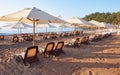 Scenic view of private sandy beach with sun beds from the sea and the mountains. Amara Dols Vita Luxury Hotel. Resort Royalty Free Stock Photo