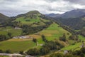 Scenic view of Pyrenees mountains with village in valley, France. Landscape of Camino de Santiago. Colorful meadows in valley. Royalty Free Stock Photo