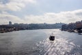 Scenic view of Ribeira and Vila Nova de Gaia from Dom Luis I Bridge in a sunlight. Porto, Portugal. The boat is floating on the Royalty Free Stock Photo