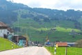 Scenic view of a road through a village in green mountains in Switzerland