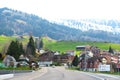 Scenic view of a road through a village in green mountains in Switzerland