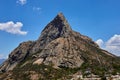 Scenic view of a rocky mountain and residential buildings under the blue sky, Bernal, Mexico