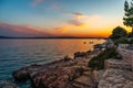 Scenic view of a rocky shoreline of a lake seen during the sunset Royalty Free Stock Photo