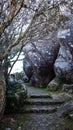 Scenic view of a rugged sandstone formation featuring a stepped path leading down its face