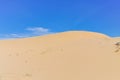 Scenic view of sand dunes under sunny blue cloud sky in Nam Cuong, Phan Rang, Viet Nam