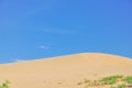 Scenic view of sand dunes under sunny blue cloud sky in Nam Cuong, Phan Rang, Viet Nam