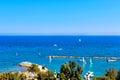 Scenic view of sandy beach with a pier with yachts and boats