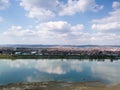 Scenic view of Sava river and settlements around Slavonski Brod during sunny day with fluffy clouds