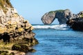 Scenic view of sea against blue sky in rocky coast