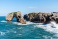 Scenic view of sea against blue sky in rocky coast