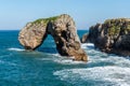 Scenic view of sea against blue sky in rocky coast