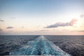 Scenic view of the sea from the stern of a luxurious cruise ship, against the sunrise on a beautiful blue sky Royalty Free Stock Photo