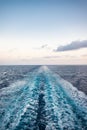 Scenic view of the sea from the stern of a luxurious cruise ship, against the sunrise on a beautiful blue sky Royalty Free Stock Photo