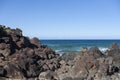 Scenic view of seascape with large rocks on coastline