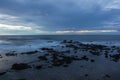 Scenic view of the seascape washing the rocky coastline under the blue sky Royalty Free Stock Photo